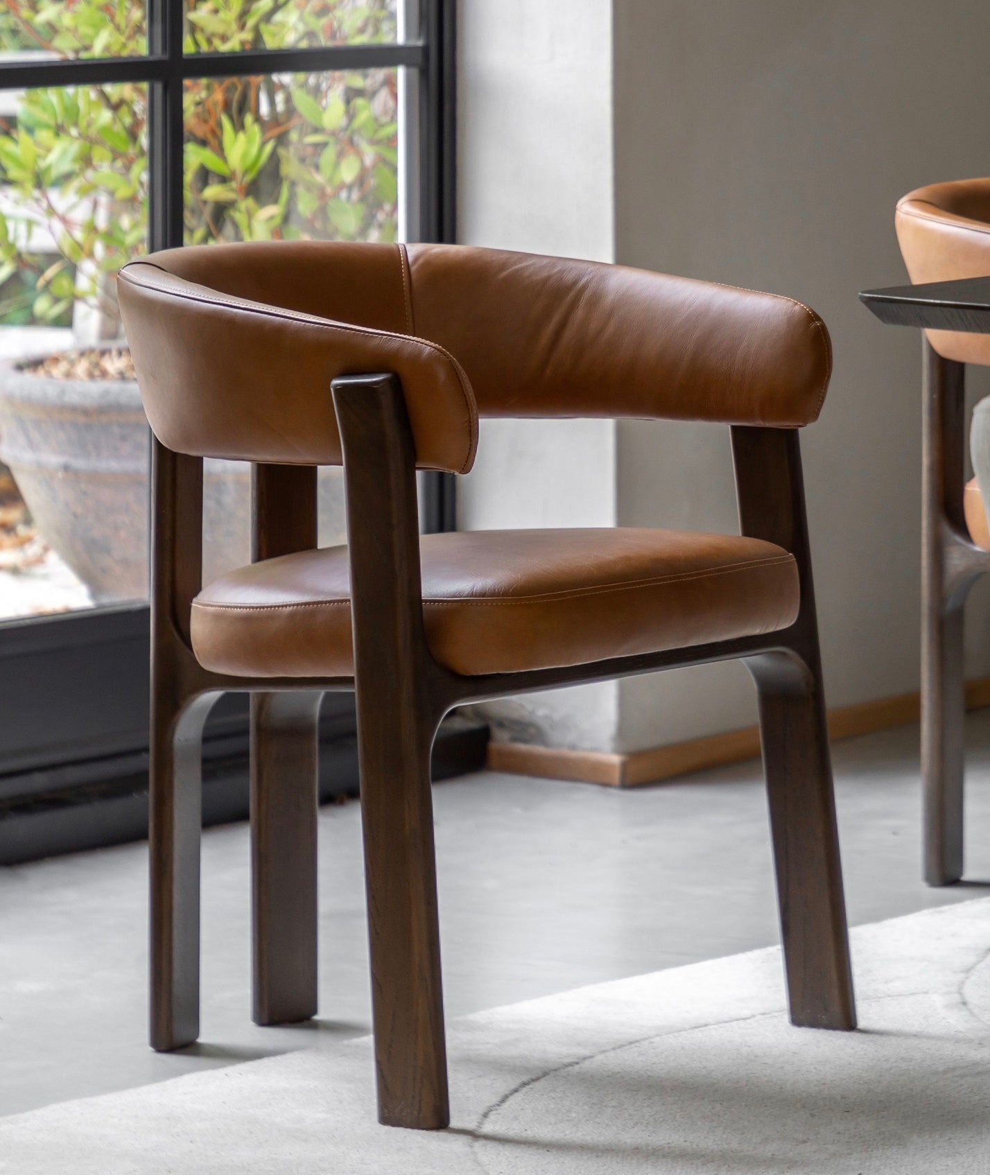 Brown leather onda dining chair with dark wood frame and comfortable armchair design perfect for dining rooms