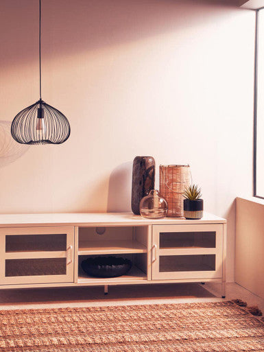 A minimalist white media console with glass-paneled doors and open shelving styled with an optik bottle vase
