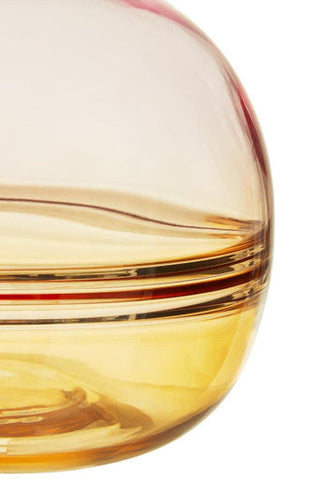 A translucent amber glass optik bottle vase with a smooth rounded body and subtle horizontal bands near the rim