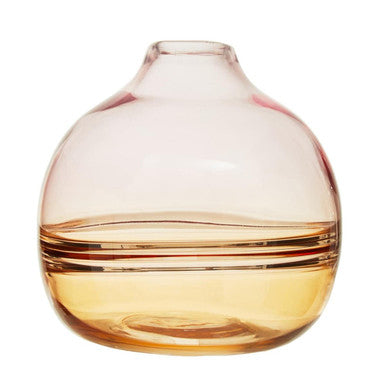 A translucent peach-colored glass optik bottle vase with a rounded body and narrow neck perfect for flowers