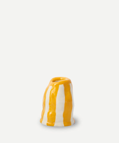 A small ceramic candle holder with vertical orange candy stripe glaze in yellow and white perfect for cozy lighting