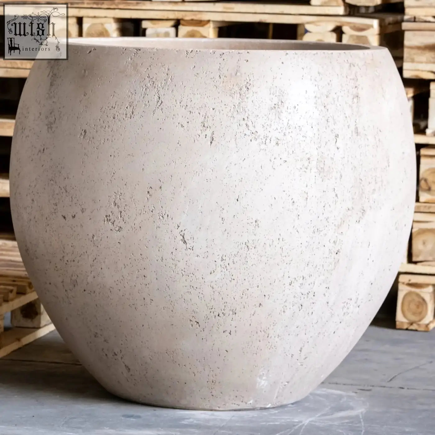 Orbello 55cm planter is a large round concrete planter with a textured light gray speckled surface and smooth curved edges