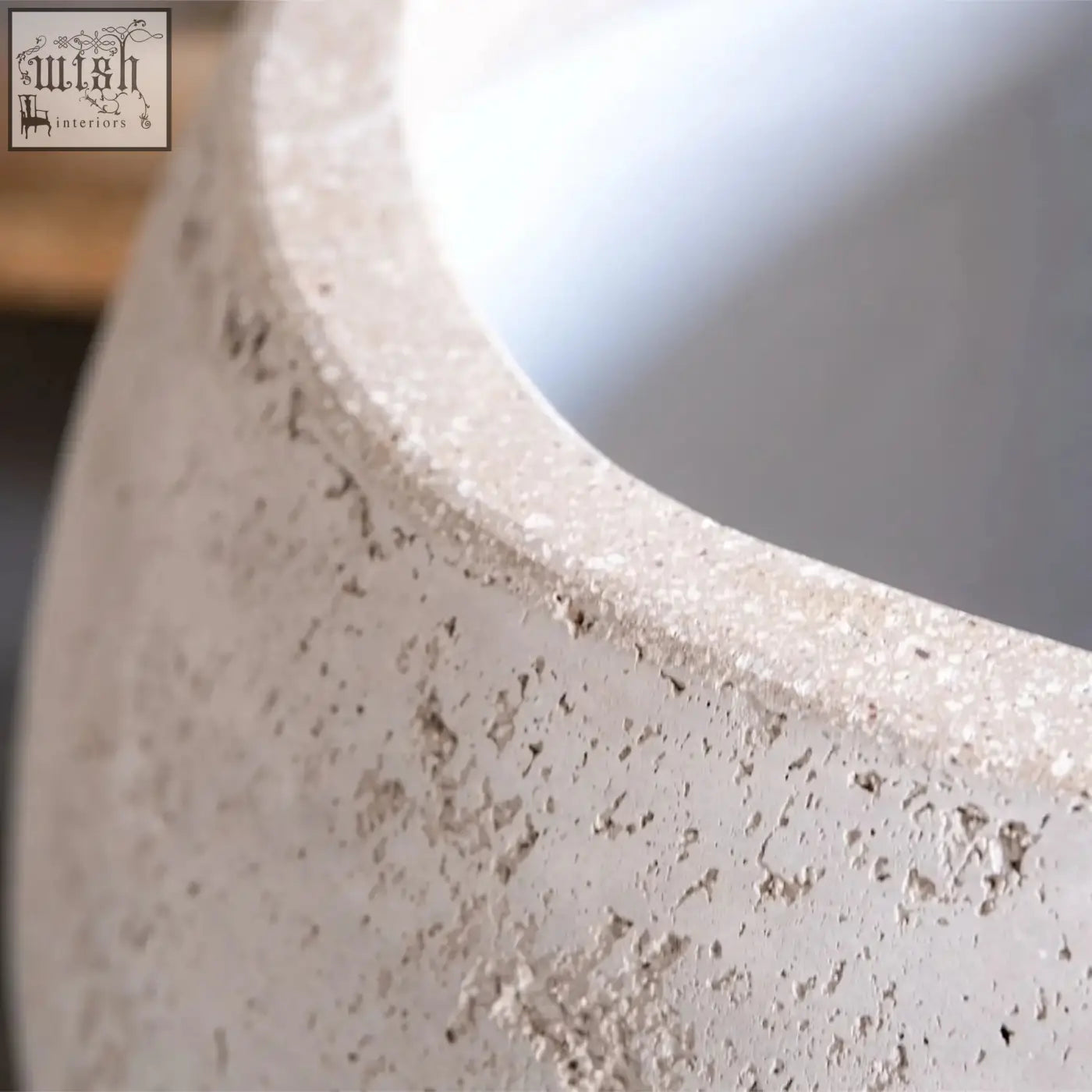 Orbello 55cm planter featuring a large light gray concrete sphere with rough speckled texture and rounded rim