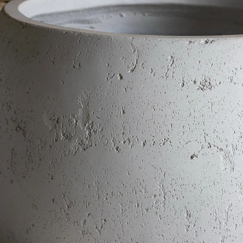Gray concrete sphere planter with rough texture and subtle speckles from orbello white mist plant pot collection