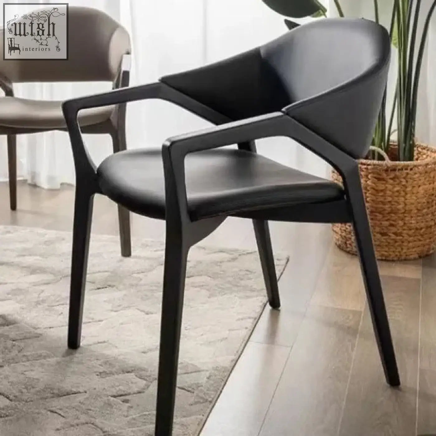 Black leather orego chair with wooden frame and sleek nīsu home design featuring dark leather upholstery and legs