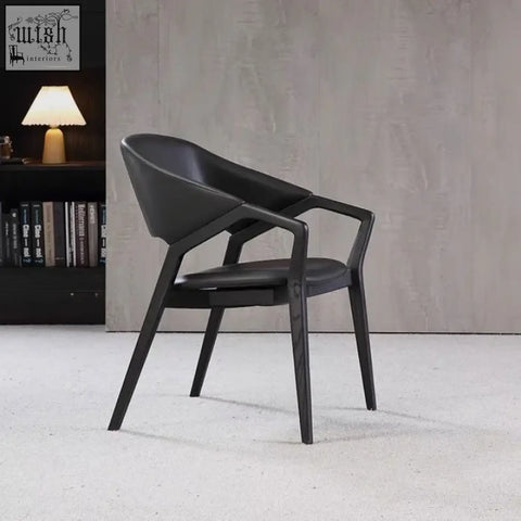 Modern black orego chair with sleek leather upholstery and wooden frame perfect for nīsu home style interiors