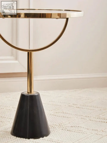 Oria black glass side table with gold-toned circular top and sleek black conical marble base