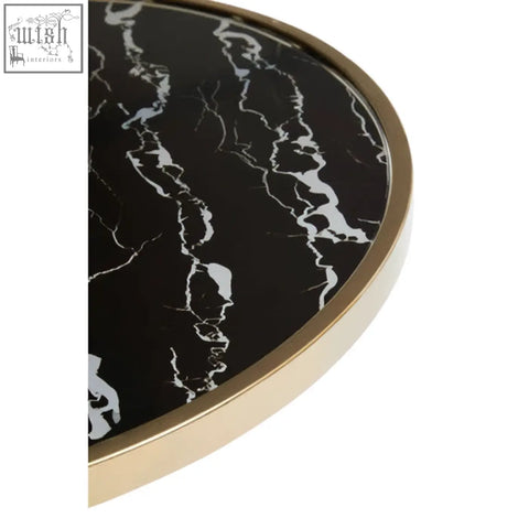 Oria black glass side table with black marble base and gold-colored metallic frame tabletop close up view