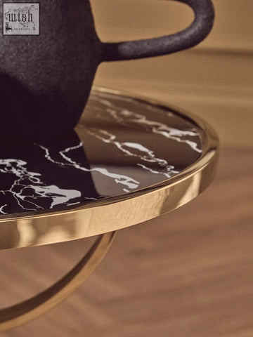 Oria black glass side table with black marble base polished gold rim and curved metal legs