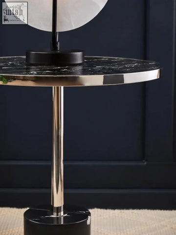 Oria black marble end table with polished gold toned stainless steel pedestal and base for stylish living spaces