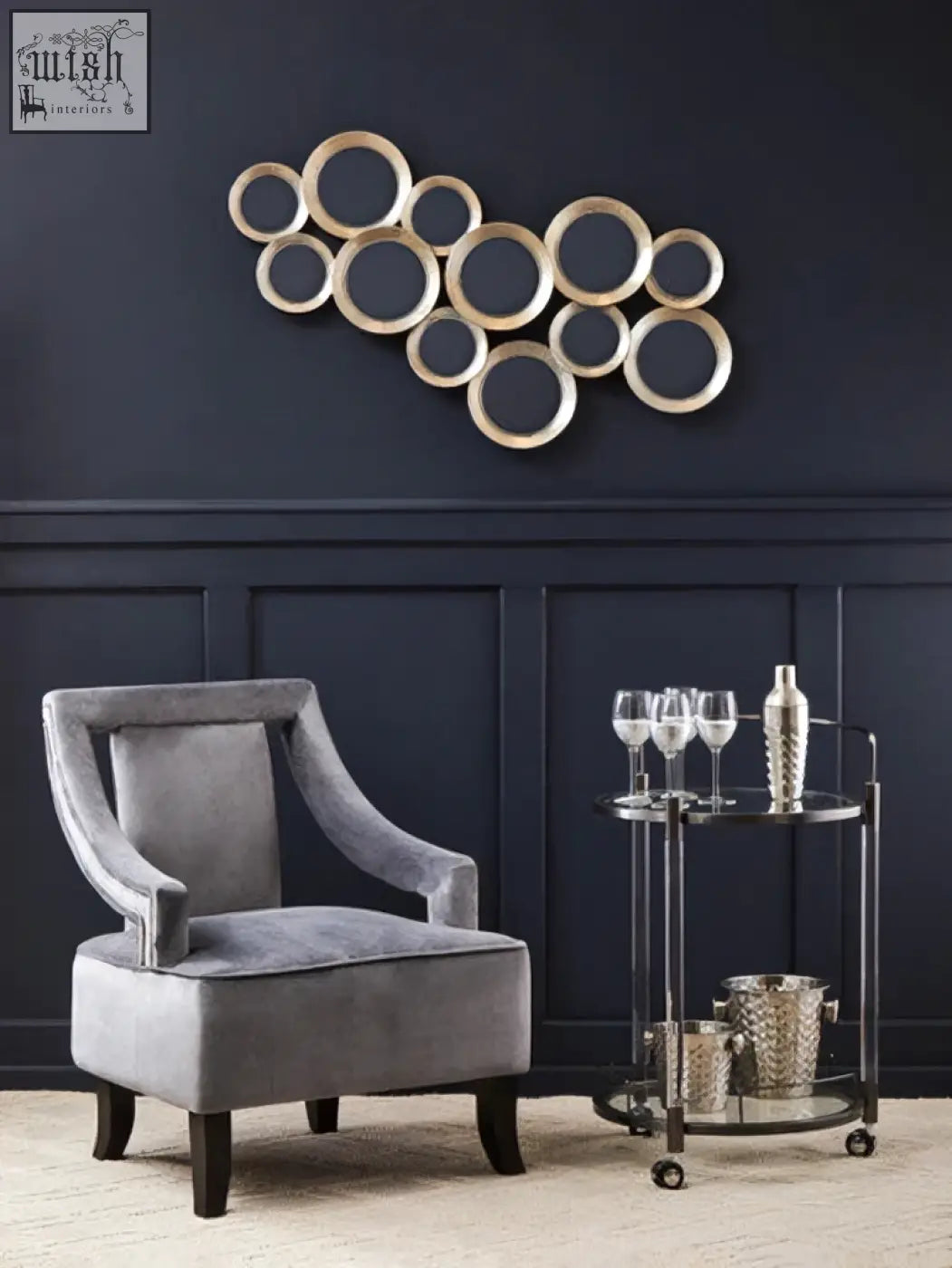 Silver-toned circular wall art with metallic finish on oria round 2 tier drinks trolley featuring tier drinks storage