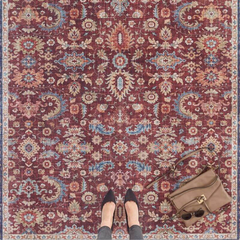 A rich burgundy oriental vivana rug with vintage medallion floral and paisley patterns in faded blues creams and golds