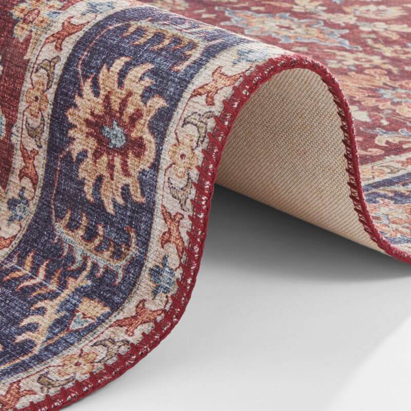 A richly patterned oriental vivana rug with deep red and navy vintage medallion and intricate floral motifs