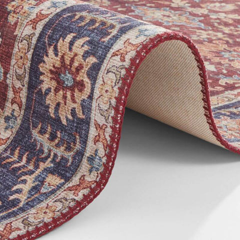 A richly patterned oriental vivana rug with deep red and navy vintage medallion and intricate floral motifs