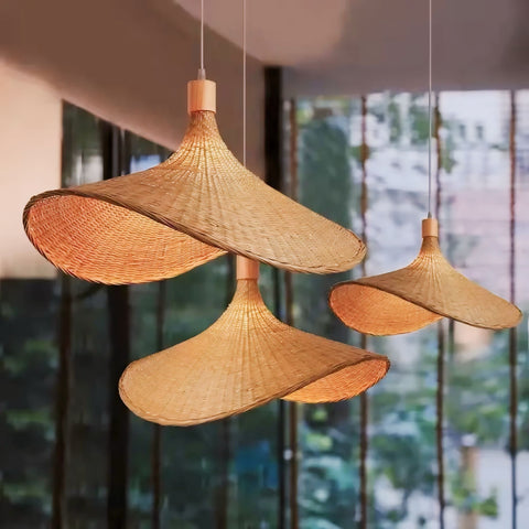 Handwoven natural rattan pendant lights with warm golden hue and elegant conical shape in Origan Light design