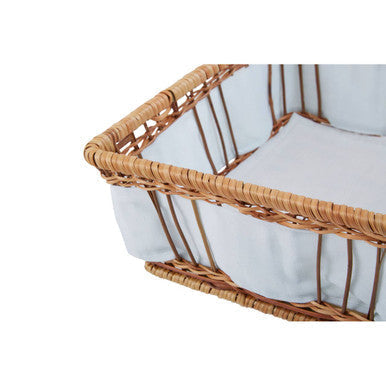 Woven wicker baby bassinet with light blue padded lining in the orla set of two natural fern baskets