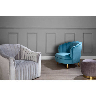 A plush light blue velvet scalloped curved armchair with gold wood legs perfect for stylish seating