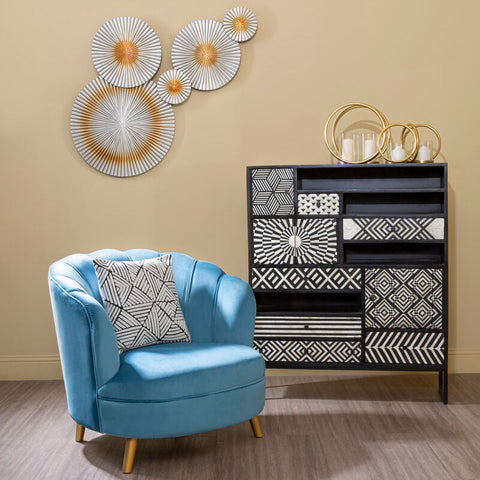 Orlina blue velvet scalloped curved armchair with gold wood legs and geometric-patterned pillow for stylish seating