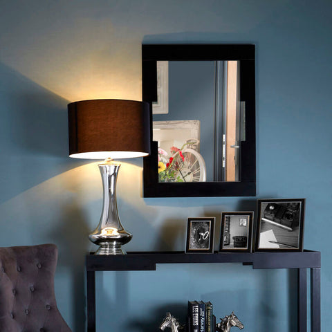 Silver metallic table lamp with dark brown fabric shade next to the osaka wall mirror on a modern wall mirror setup