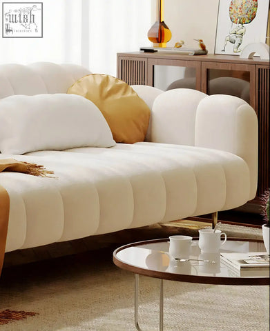 Cream-colored osamu sofa with tufted design and plush fabric perfect for a modern designer living room setup