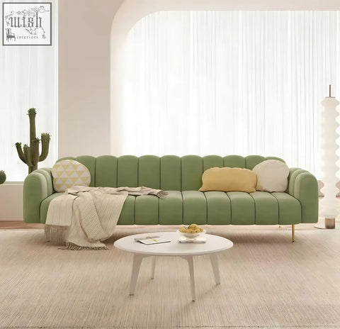Modern designer osamu sofa in sage green with tufted segmented back and curved armrests for living room seating