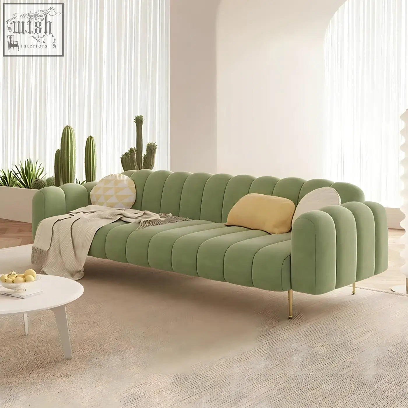 A modern designer osamu sofa in sage green velvet with quilted design and gold legs perfect for your living room