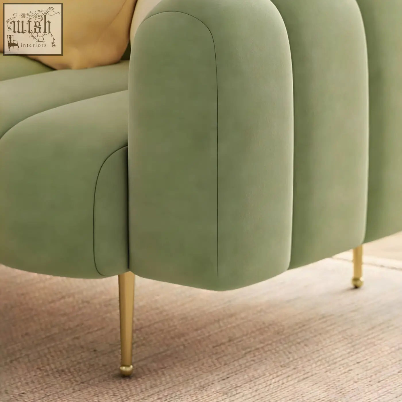 A sage green velvet osamu sofa with tufted segmented armrests and slim gold legs perfect for a modern designer living room