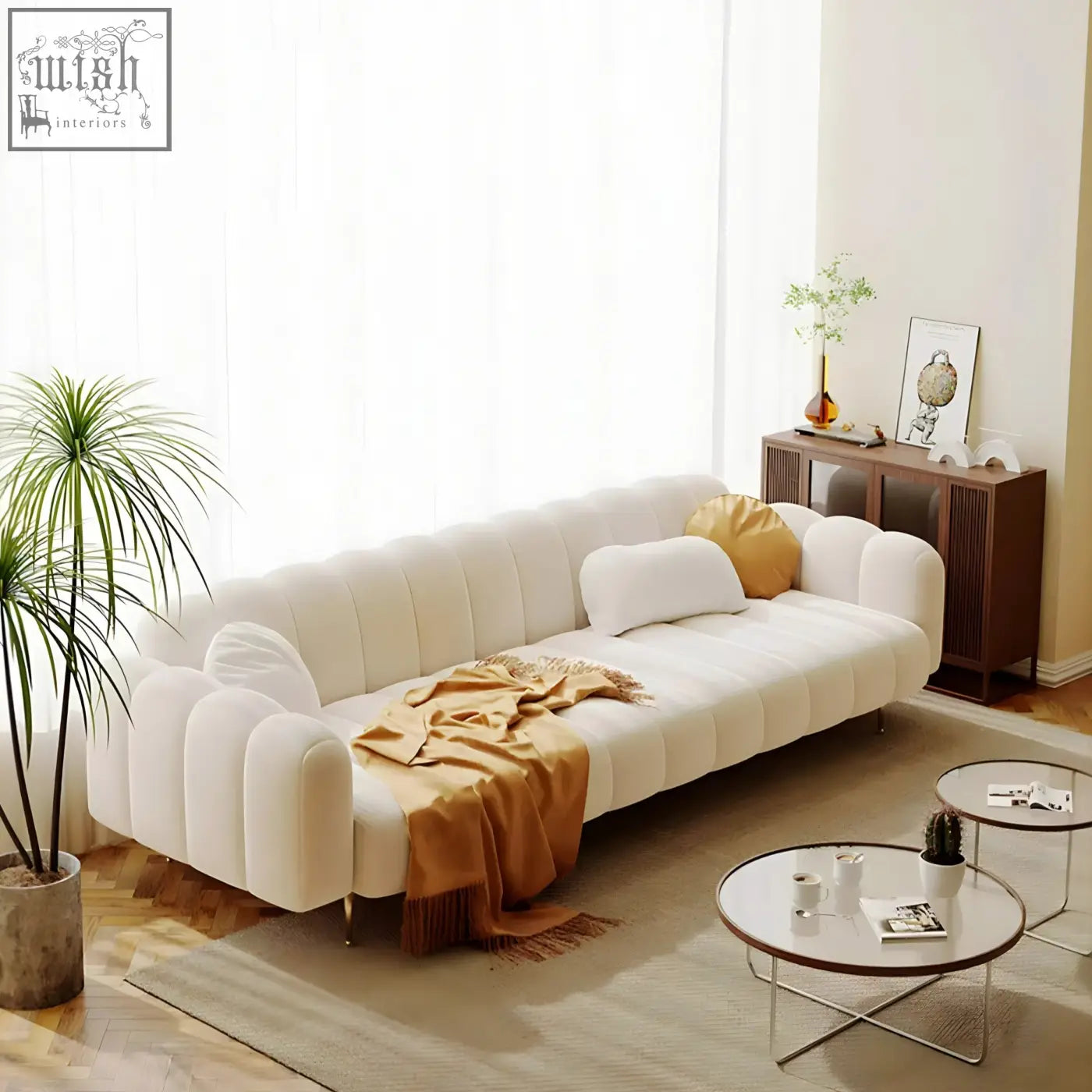 Cream-colored osamu sofa with tufted back and plush rounded armrests perfect for a modern designer living room