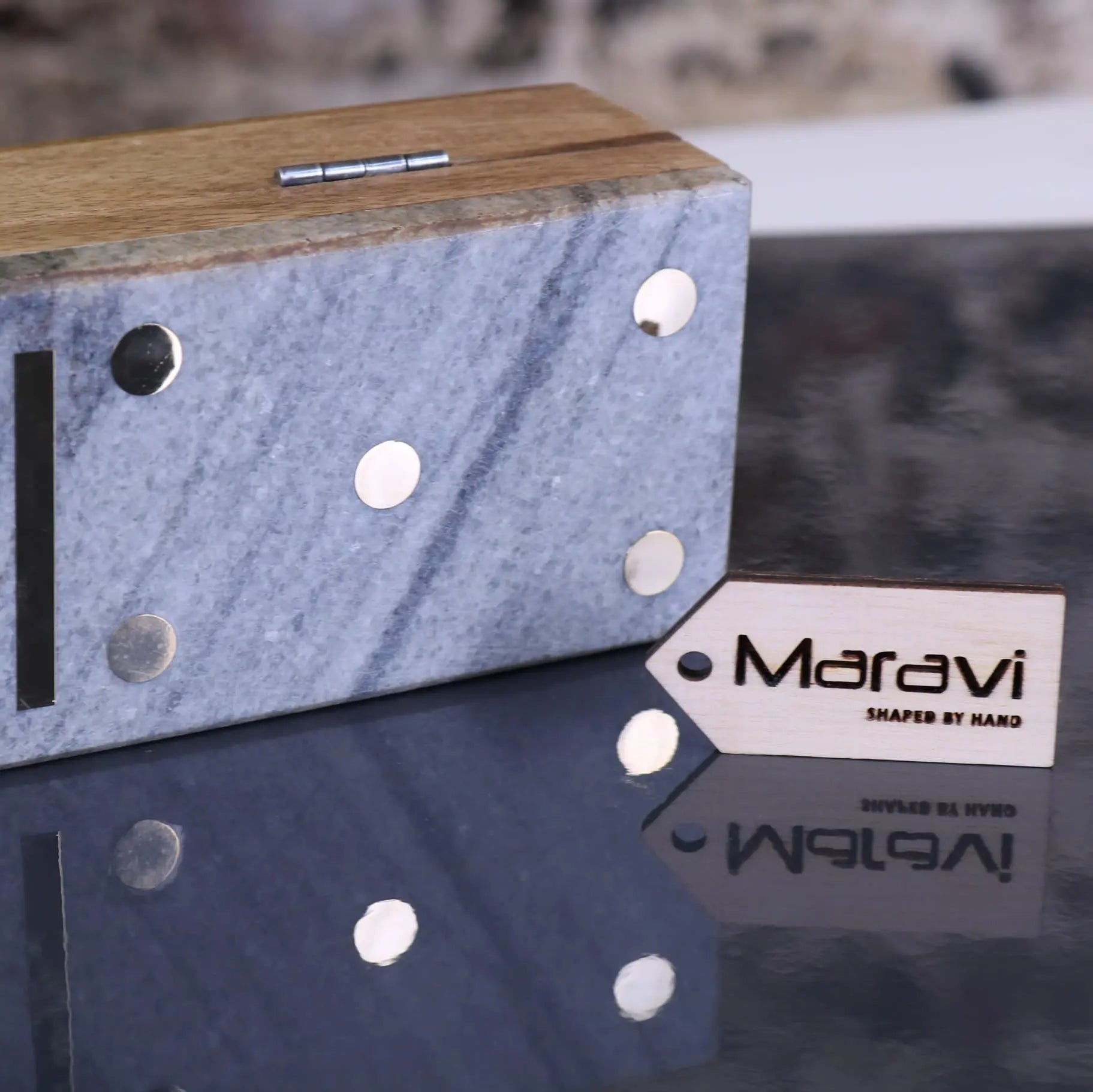 Blue marble box with wooden top and silver rivets branded maravi is a luxury dominoes set case