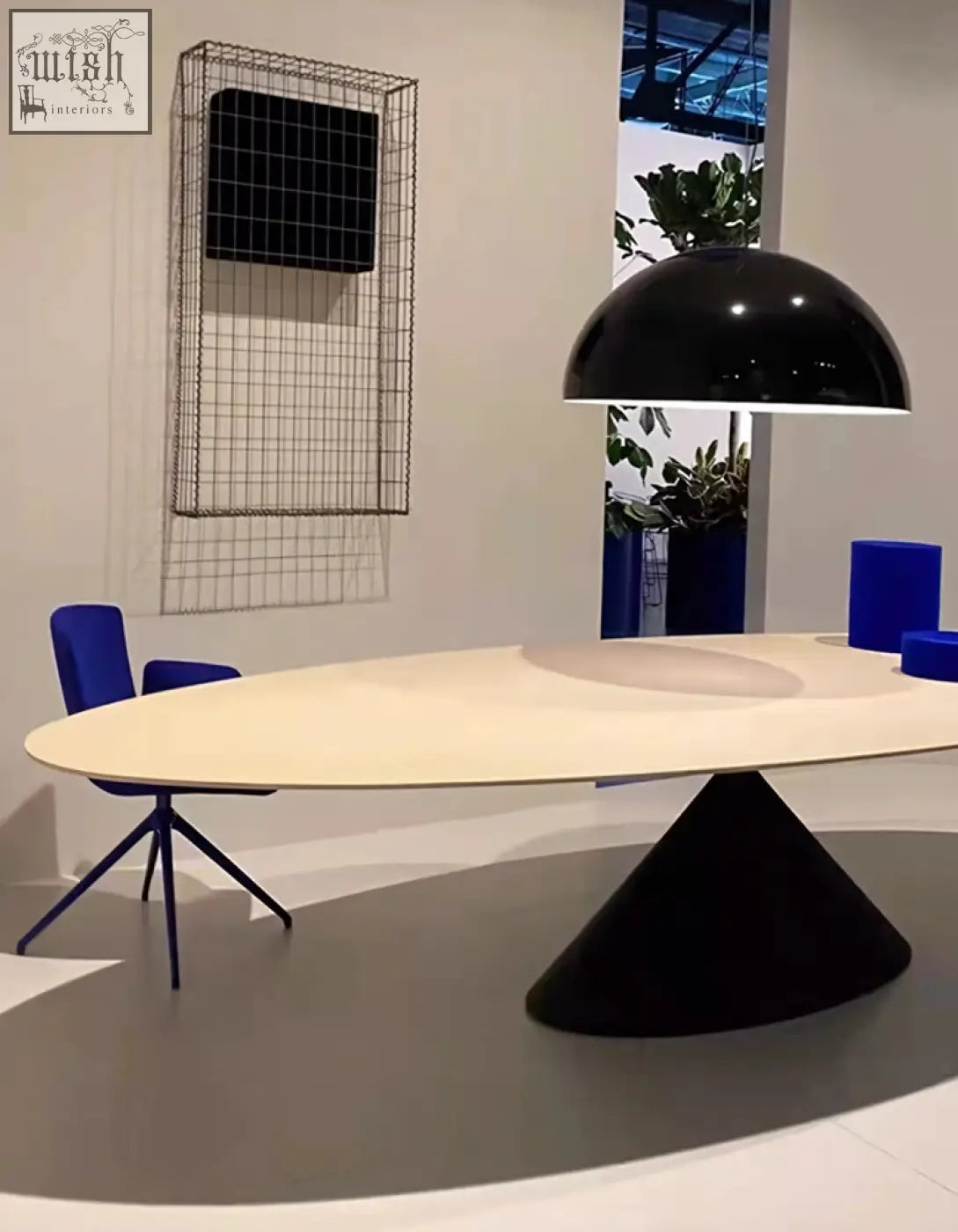 Black dome-shaped pendant lamp with modern design over osim oval dining table with marble top for oval dining