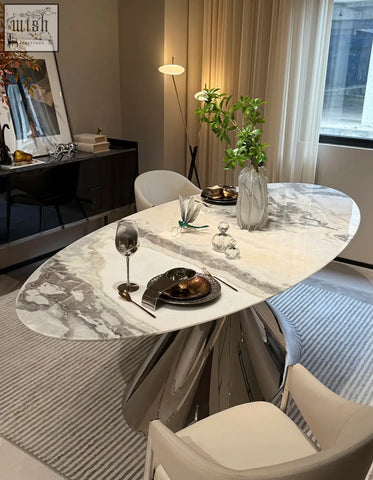 Osim oval dining table with a white and gray marble top and polished chrome legs perfect for elegant oval dining