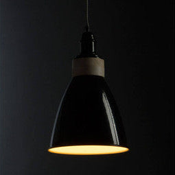 Oslo black pendant light with a black enamel finish and warm glowing light for cozy indoor lighting
