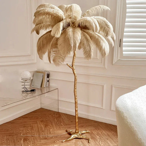 A tall floor lamp with cream ostrich feather canopy and copper resin base perfect for bedroom bedside lighting