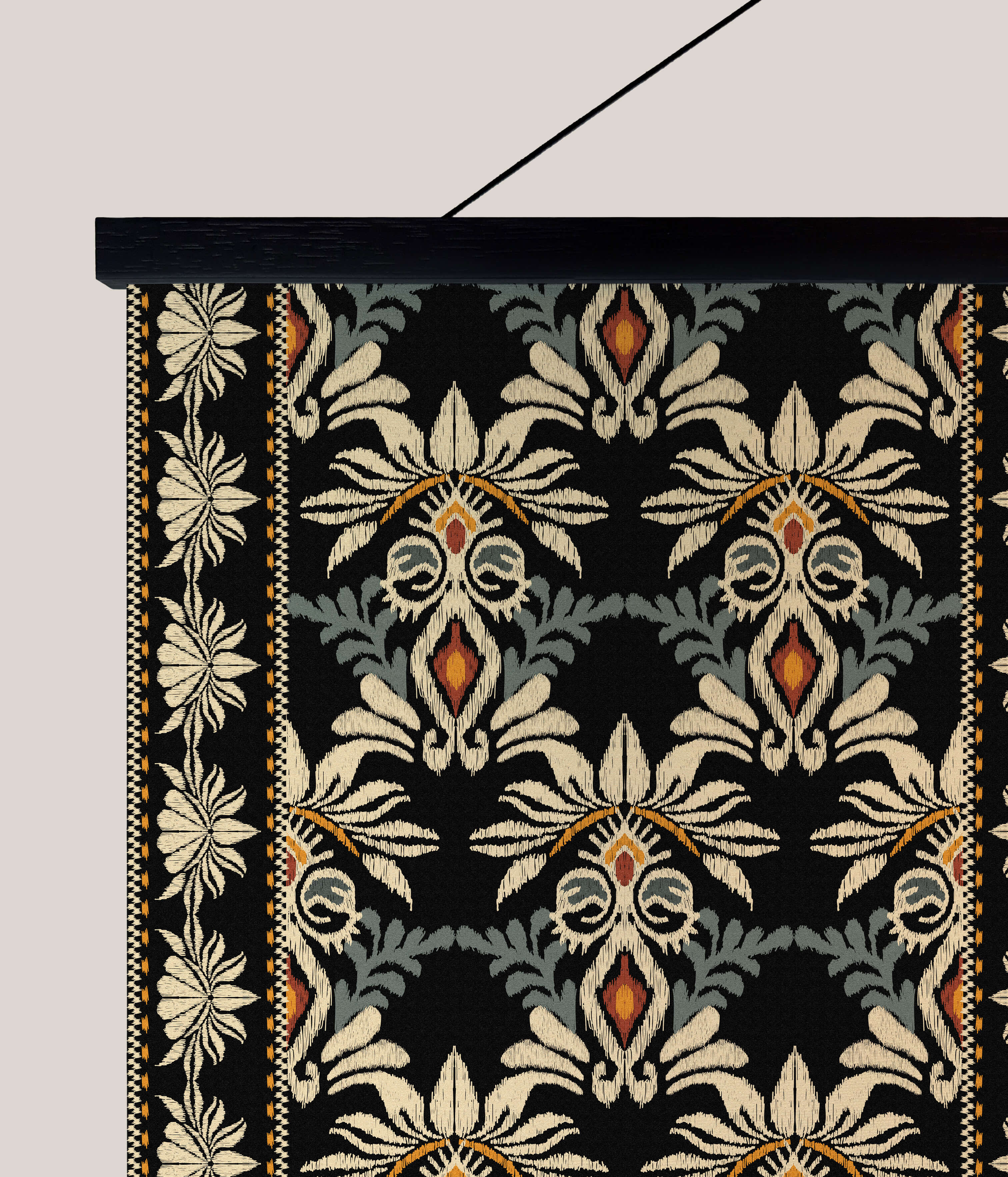 Black ottoman tapestry wall hanging with intricate cream and orange floral patterns on textured fabric