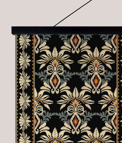 Black ottoman tapestry wall hanging with intricate cream and orange floral patterns on textured fabric