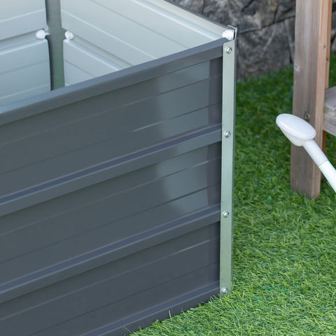 Dark gray galvanized steel raised garden bed with silver framing and installation gloves for backyard planting