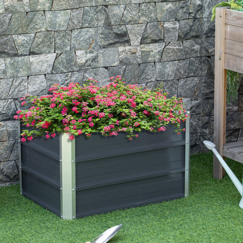 Dark gray raised garden bed with silver metal sides filled with pink flowers and included installation gloves