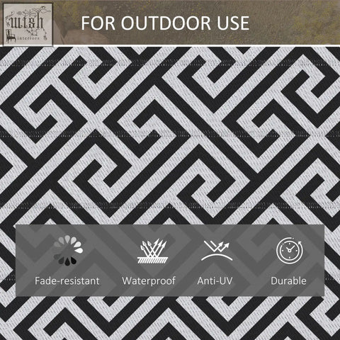 Black and white geometric outdoor rug with woven plastic straw texture perfect for road tour and camping use