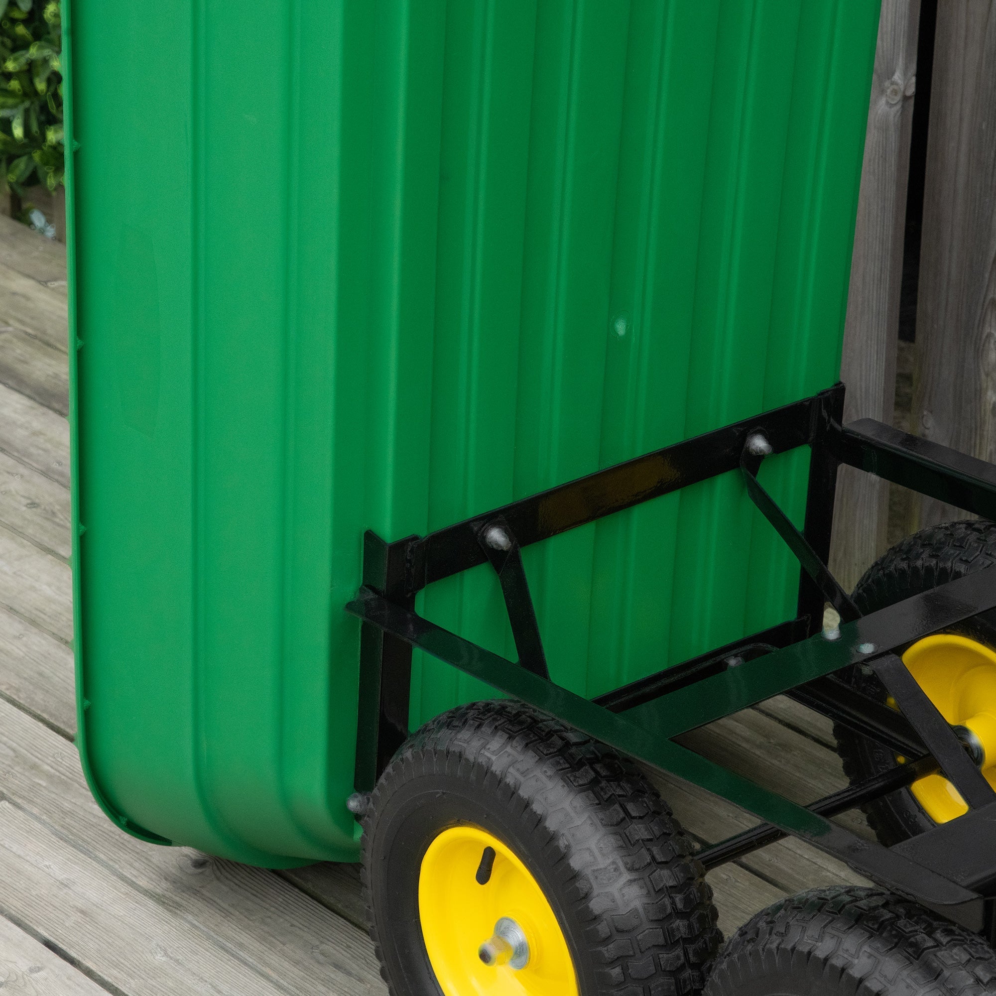 Green corrugated plastic garden cart mounted on black metal wheeled trolley with yellow rims for heavy duty use