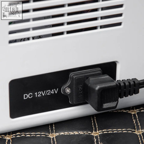 White plastic electric heater with black power plug and fuse labeled dc 12v 24v for portable refrigerator foldable handles