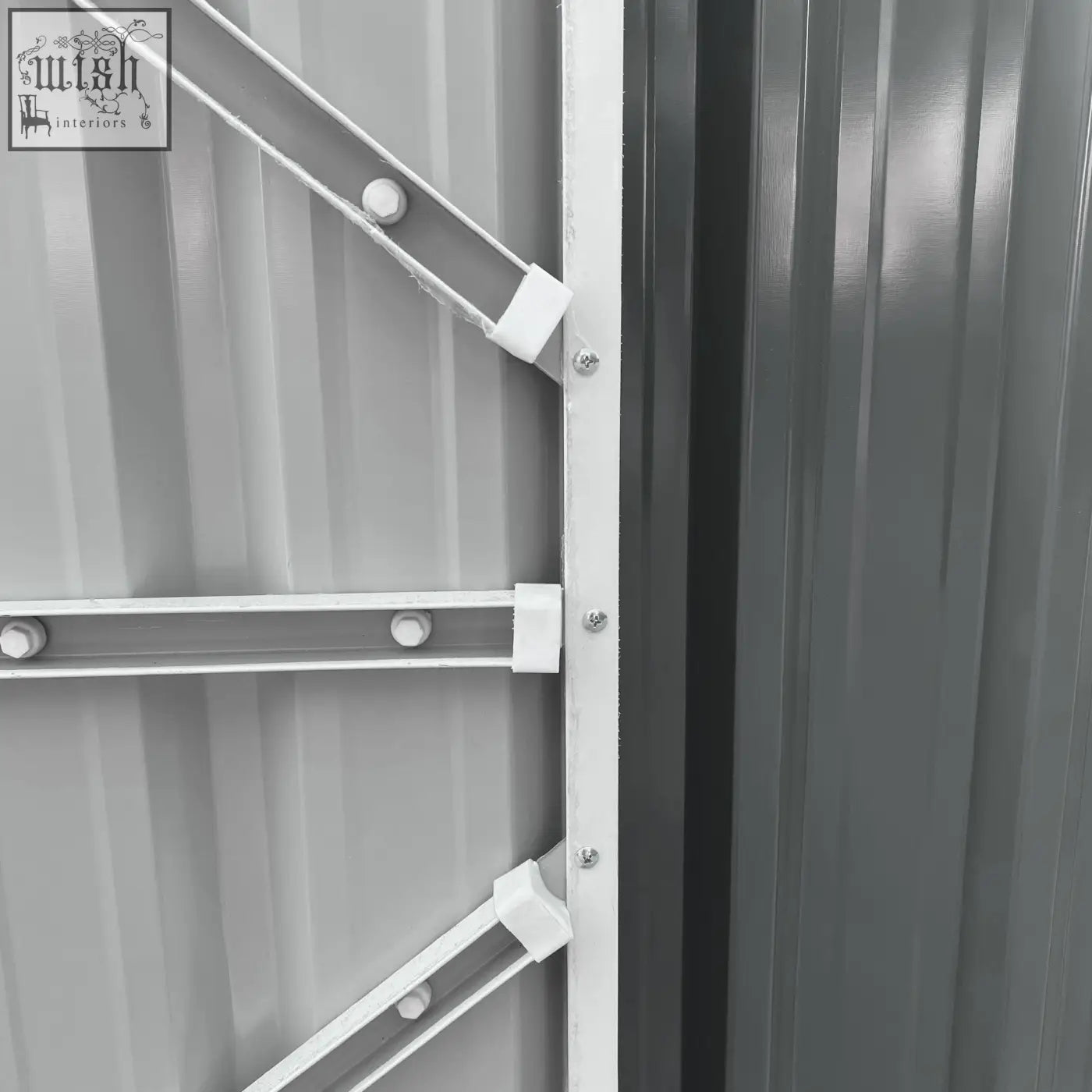 White metal support brackets with plastic connectors securing a gray corrugated panel on an outsunny outdoor garden storage shed