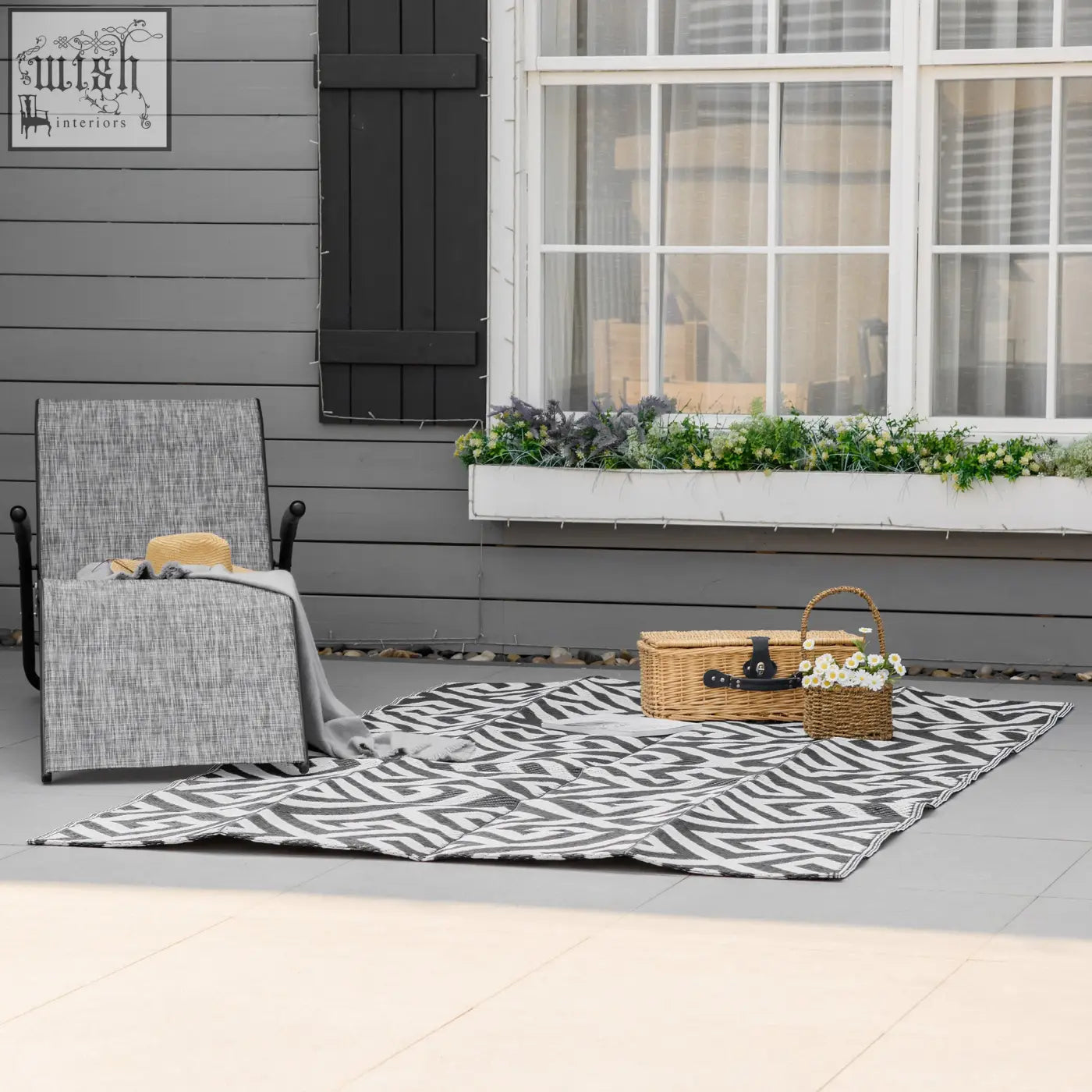 Black and white zebra-striped outdoor rug made of plastic straw perfect for road tour picnics and camping