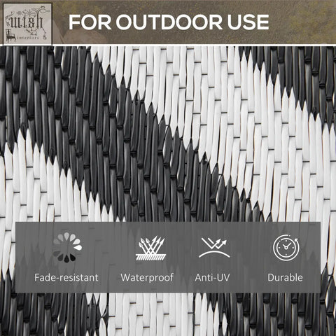 Black and white woven outdoor rug with durable plastic straw pattern perfect for road tour and camping use