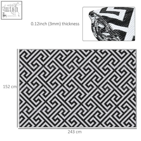 Black and white geometric patterned outdoor rug made of plastic straw with woven texture perfect for road tour use