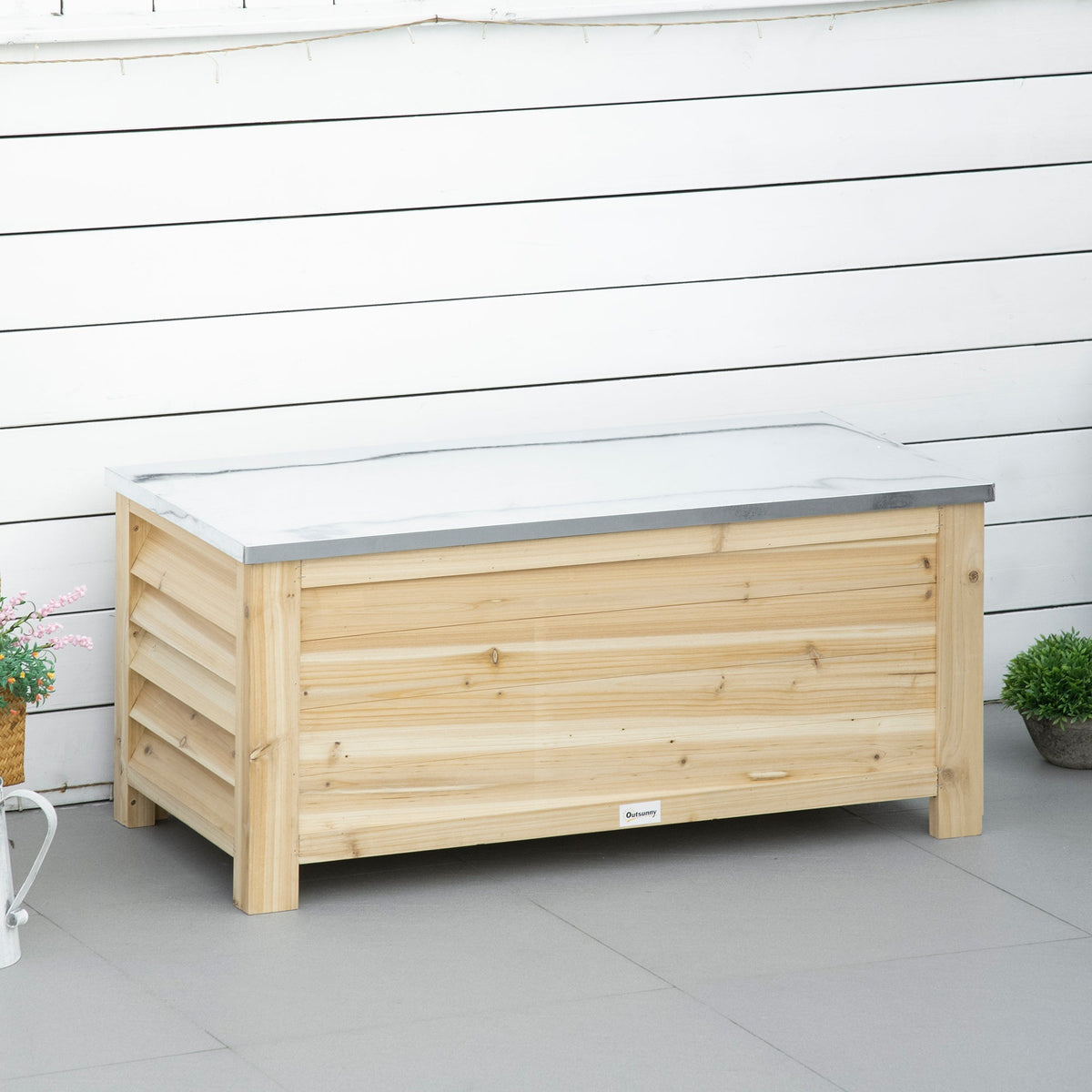 Light wooden outdoor storage box with white marble-effect galvanised metal top for garden and terrace use