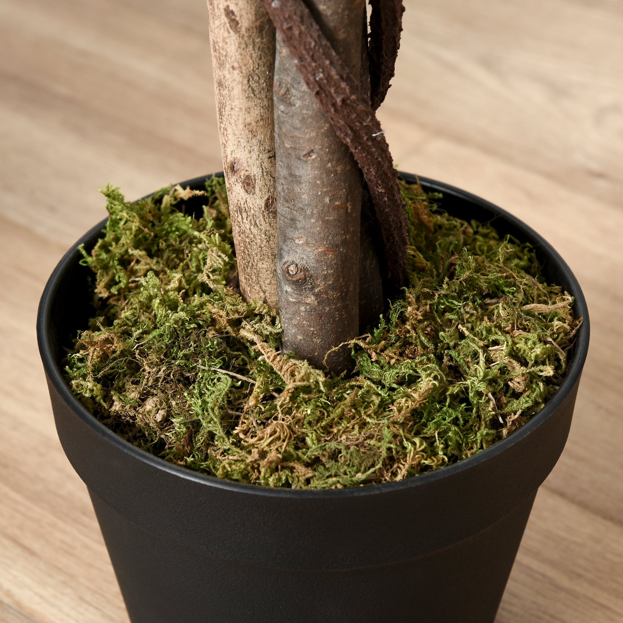 Black pot filled with green moss and a faux tree trunk for an outsunny artificial ficus with cement-filled pot design