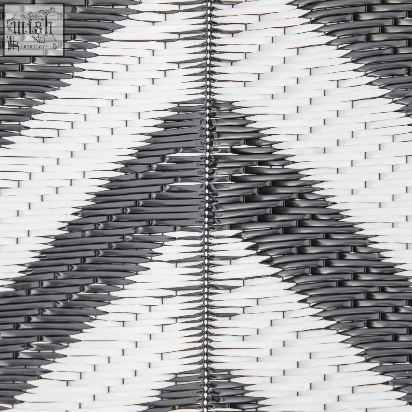 Black and white woven plastic straw outdoor rug with central seam perfect for road tour camping and picnics