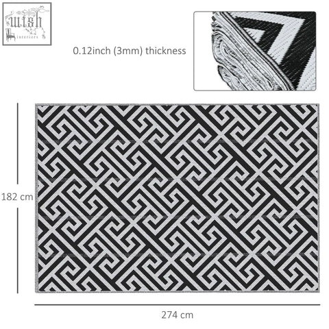 Black and white geometric patterned outdoor rug made of plastic straw with thick woven texture perfect for road tour use