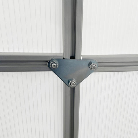 Gray triangular metal bracket with bolts securing silver aluminium frame means in outsunny polycarbonate greenhouse