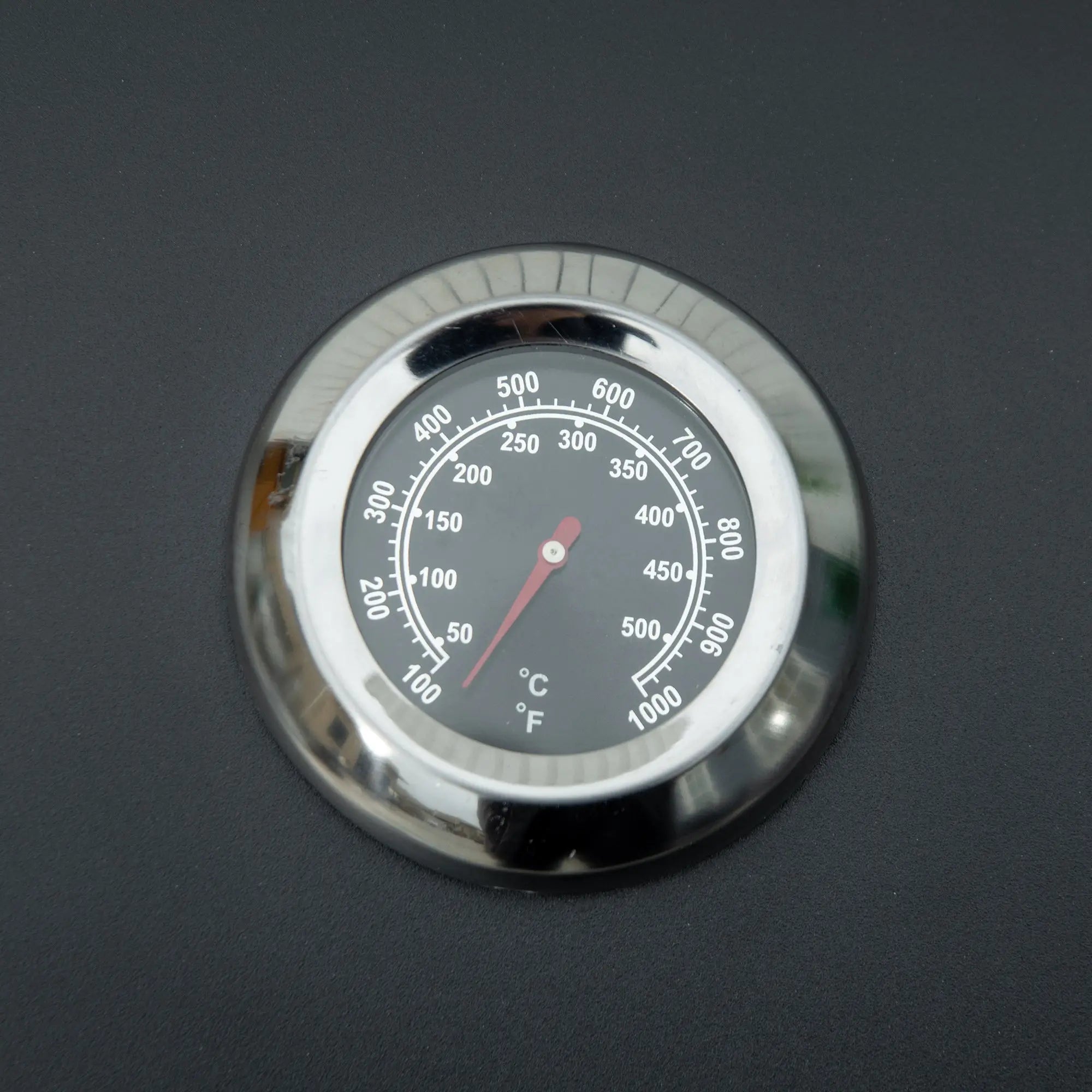 Chrome-finished circular grill thermometer with black face and red needle on outsunny carbon steel portable 2 burner grill net